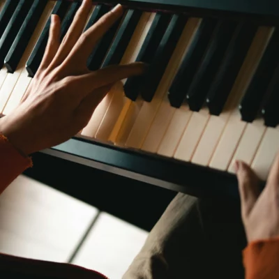 mão masculina tocando piano.