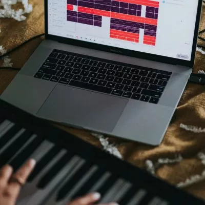 mãos de mulher tocando piano digital.